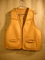  This braided leather vest has front slanted yokes, a back yoke, and two slit hip pockets. Like every thing that I build, it was made in the USA and the moccasin cowhide leather used for it was tanned in the USA. 