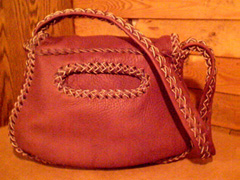  This picture is of the back view of the purses showing it's back pocket and a better view of how the strap is built. 