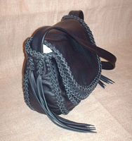  This side view of the purse provides a good view of the braided construction and shows a different angle of the many kinds of braid it is put together with. 