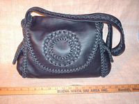  This picture is of the purse with ruler in front of it to help realize the  12.5" wide by 9" high size of it. 