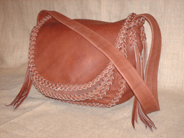  These four pictures show a custom, handmade shoulder leather bag made with Rust colored moccasin cowhide leather - it has no hardware, no lining, nor is any thread used in this braided construction. The strap of this one doesn't have braiding down the length of it. 