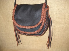  The strap on this bag is not braided ...and it has no applique on the flap. The tassels hanging from the straps ends are quite long ...around 12". 