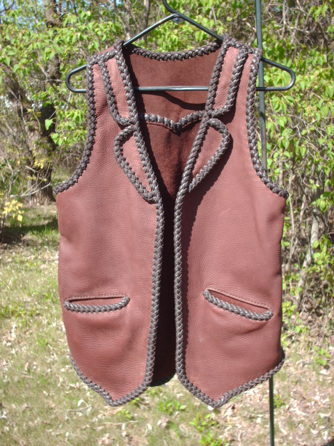  This two tone leather vest has what I've come to call split front lapels. It also has a back pointed yoke, split hip pockets, and a back/bottom draft flap. 