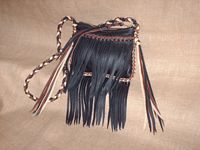 fringed leather bag with a braided strap. 