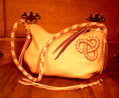  These four pictures are of the large version of this bag style. It is two-toned, has a 12"+ large brass zipper (YKK #10), an 8 lace braided strap, with my tri-loop in the upper corner. 