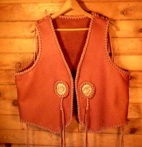  This custom leather vest was made for a guy who sent me his vest to go by to build one for him. He also supplied the snake skin for the inlay. I rather did the side and top seams free hand, as well as the braiding around the snake skin. 