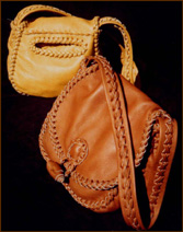  This picture is of the original two sizes of these 'roll button' purses that I make. I've now added a third size - an Xtra large roll button purse. They are all made of only leather - no thread, lining, hardware, etc. Like everything that I make, they are very durable and long lasting. This picture shows the pocket that is often on the back side of this style. 
