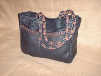  This Black tote was built using two tone (Black and Mahogany) 1/4" wide laces of the same material it was built with. It has 8 strand round braided straps (without tassels). 