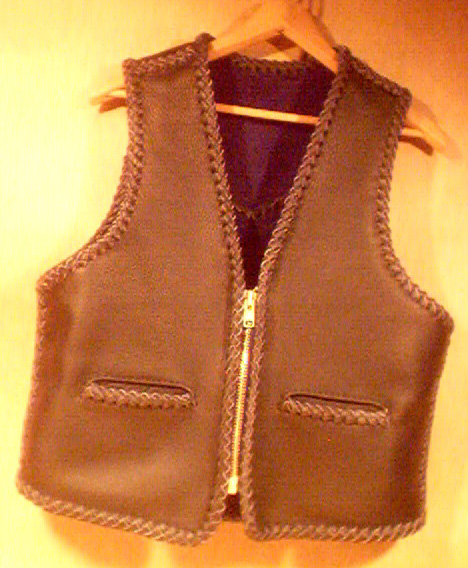  This black leather vest had slit pockets and a large brass (YKK #10) zipper. It has a back pointed yoke and unlike the majority of my vest, the bottom is squared off around its whole length. I probably added a zipper pullafter the picture was taken. 