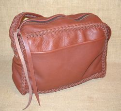  This messenger bag is 12" wide by 10" high by 4" with a 16" long zipper that extends down each side a bit. It has four pockets - three that are on the front and sides, and another on the back/inside. It has a long strap with a braid down the center of it. 