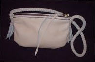  The bag is entirely made with Cream leather. It has a pretty short strap that has quite short tassels. 