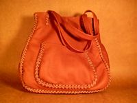   This large Rust colored tote was also braided with a more elaborate braid. It has another pocket on the back of it just like the one seen here on the front of it. 